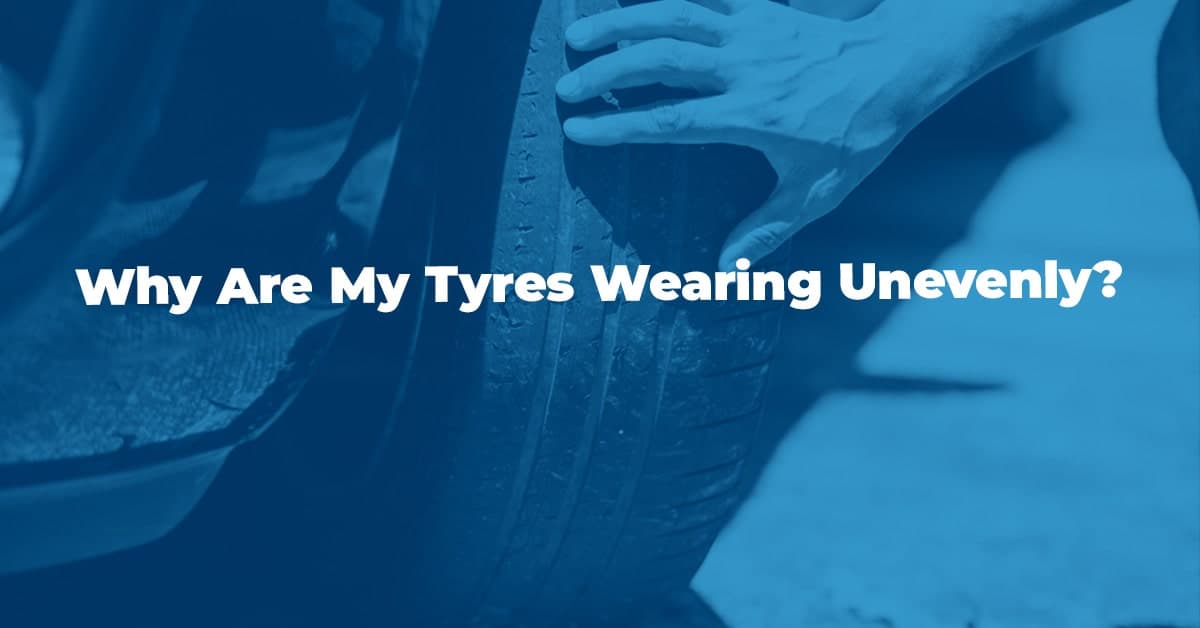 The article title over someone checking the tyre tread for uneven wear, in a blue overlay.